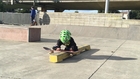 Little Boy Rides Skateboard at Skate Park