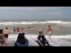 Beachgoers form human chain to help lifeguards rescue people drowning