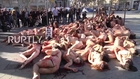 Spain: Caged, bloody, and naked, animal rights activists decry fur industry in Barcelona