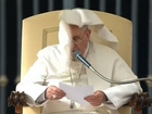 Windblown Pope Francis prays for Ukraine